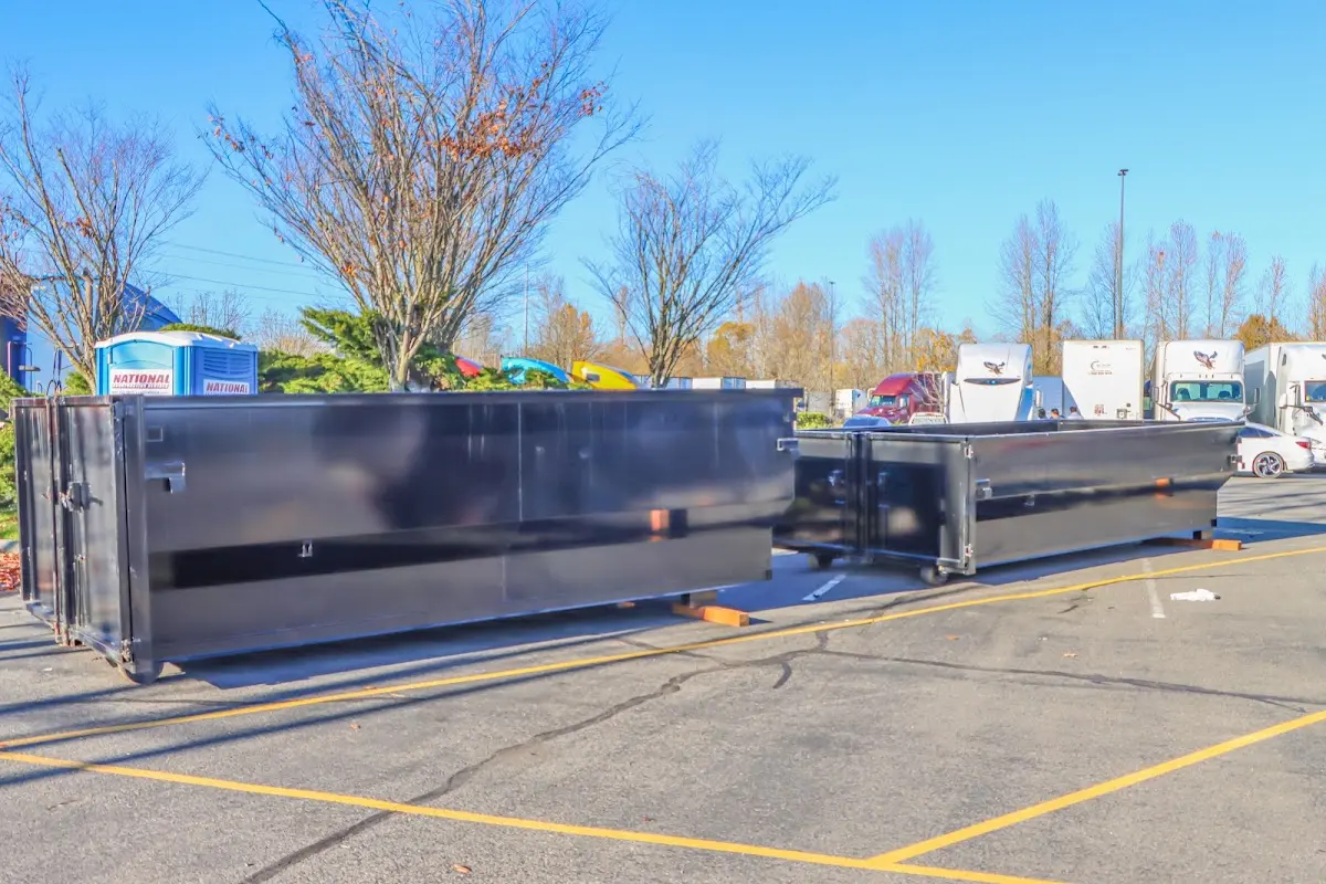 Professional dumpster rental service with roll-off container on residential driveway in Hutchinson